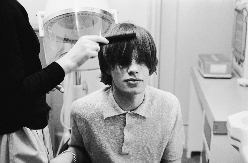 Mick Jagger having his hair styled at the BBC studios before an appearance on television, 1963.