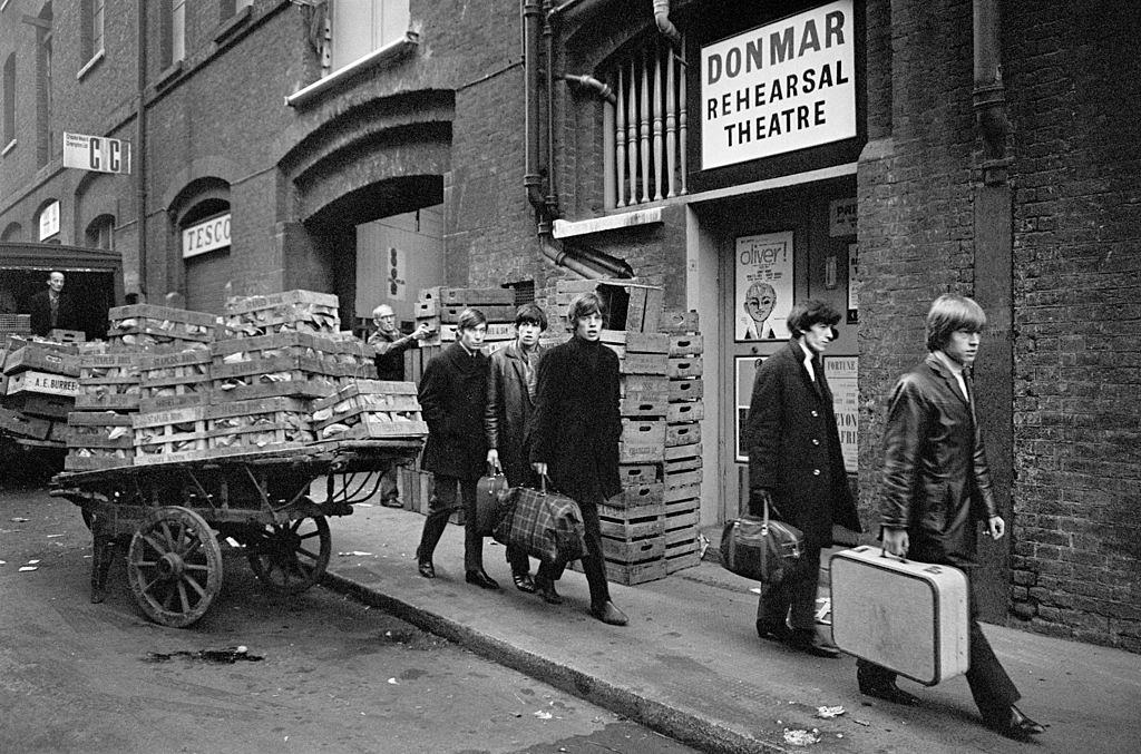The Rolling Stones file down a Covent Garden back street in 1963