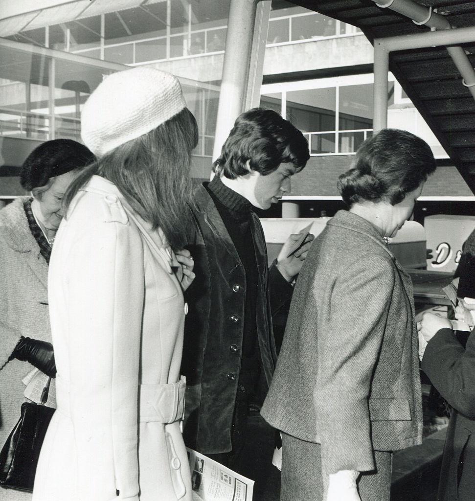 Mick Jagger carries a ticket as he stands in a queue, April 27, 1964.