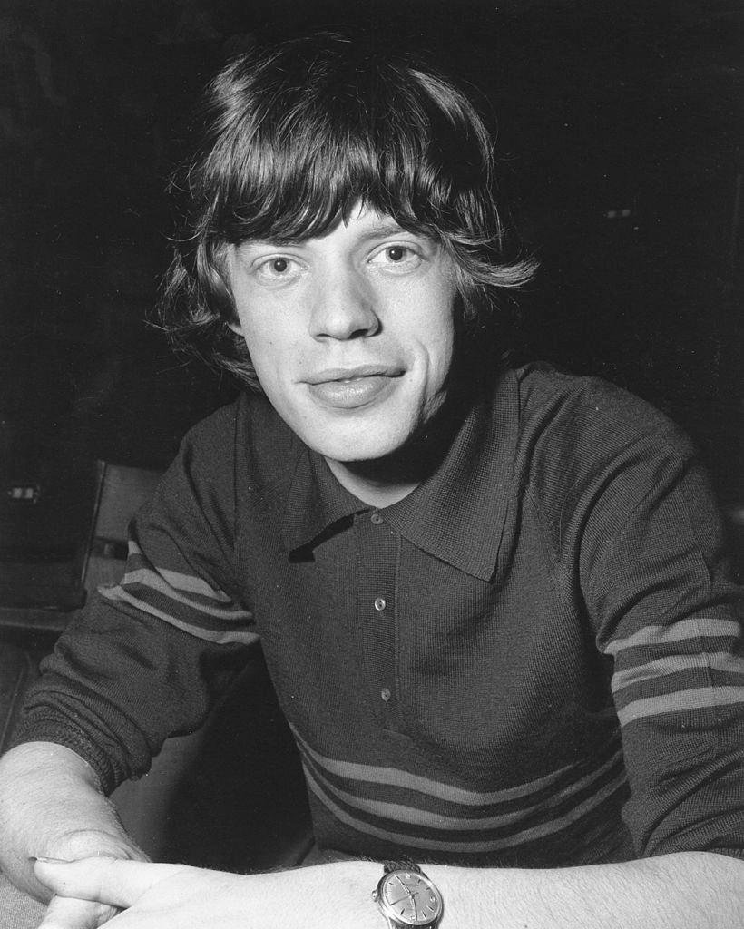 Mick Jagger hangs on the railing of a staircase in circa 1965 in London.