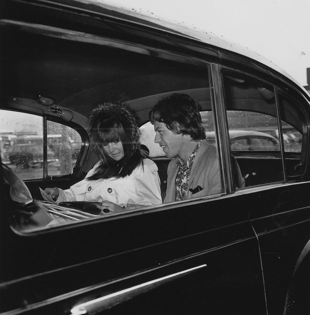 Mick Jaggeron with Chrissie Shrimpton in the back of a car, 1965.