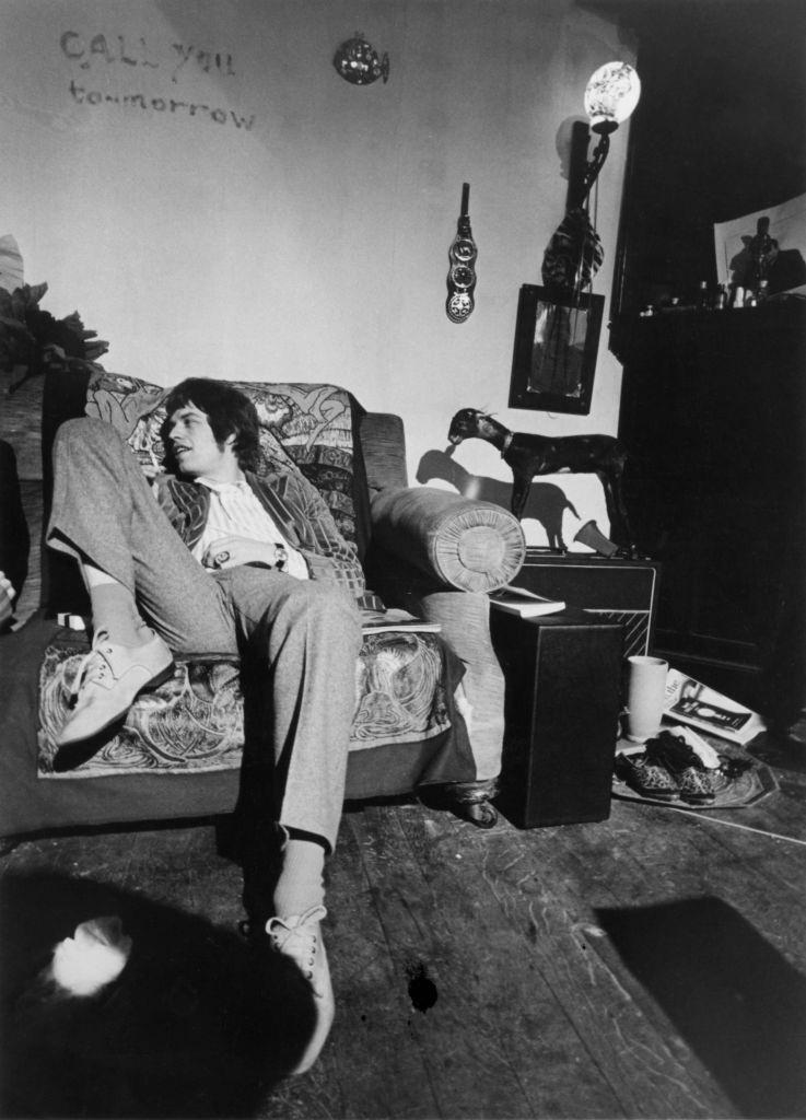 Mick Jaggeron lounging on a sofa, circa 1967.