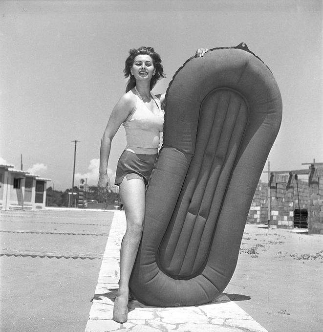 Sophia Loren posing on the beach with a dinghy, Ostia, 1953.