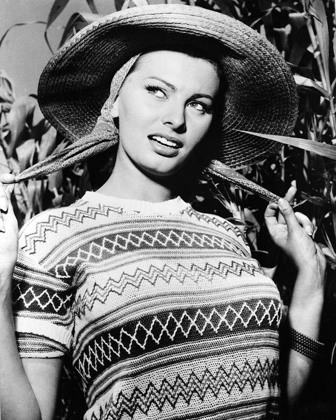 Sophia Loren in a short-sleeve jumper and a wide-brim straw hat, circa 1950.