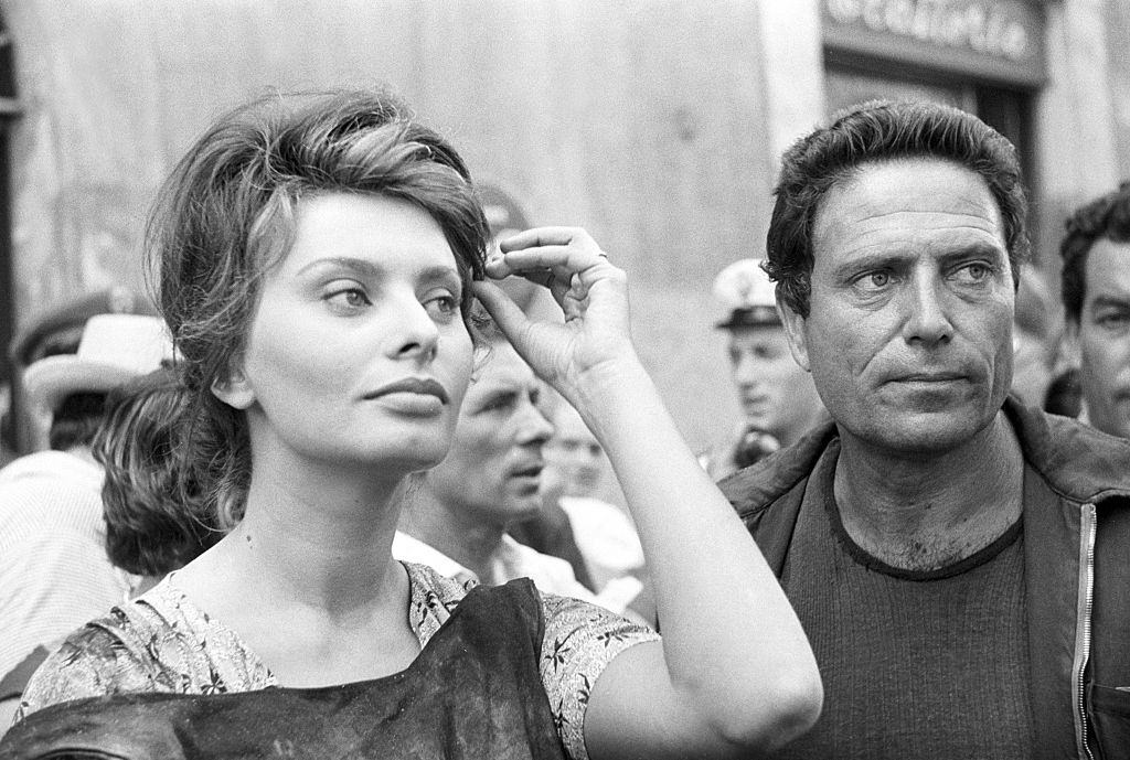 Sophia Loren with Raf Vallone before appearing in a movie scene, 1960.