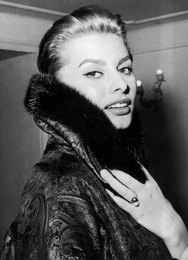 Sophia Loren, wearing a coat, 1956.