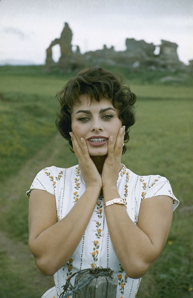 Sophia Loren as she poses with her hands on her cheeks, 1957.
