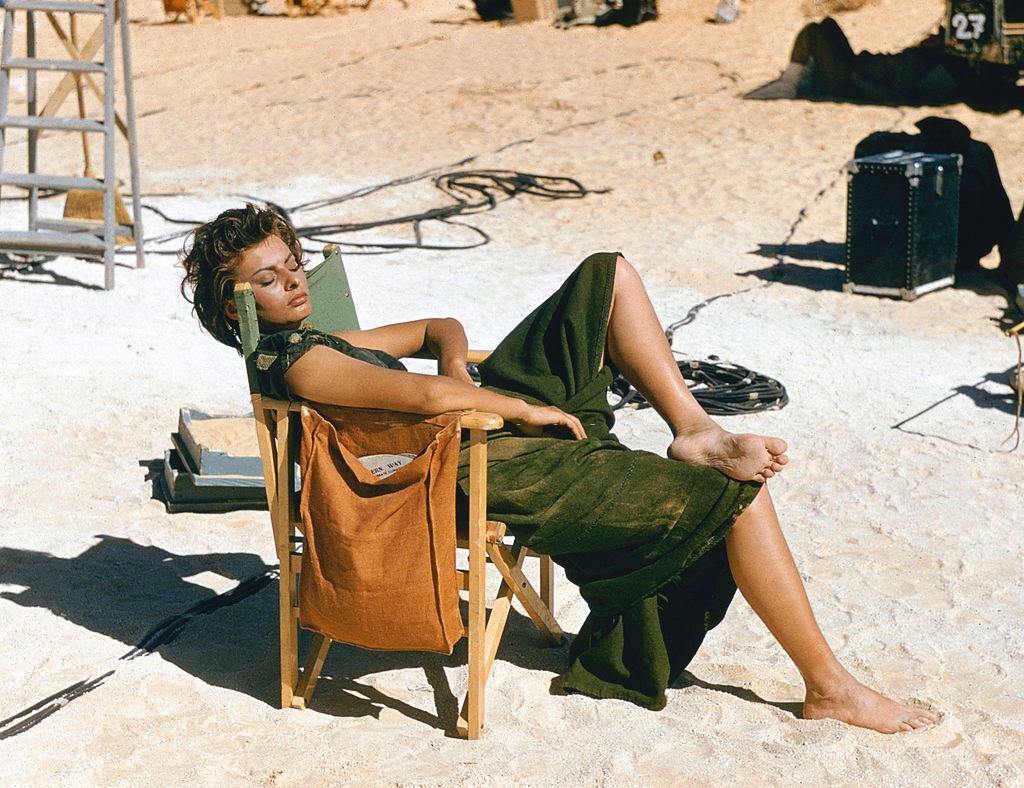 Sophia Loren relaxes on the Libyan set of the desert adventure film 'Legend of the Lost', 1957.