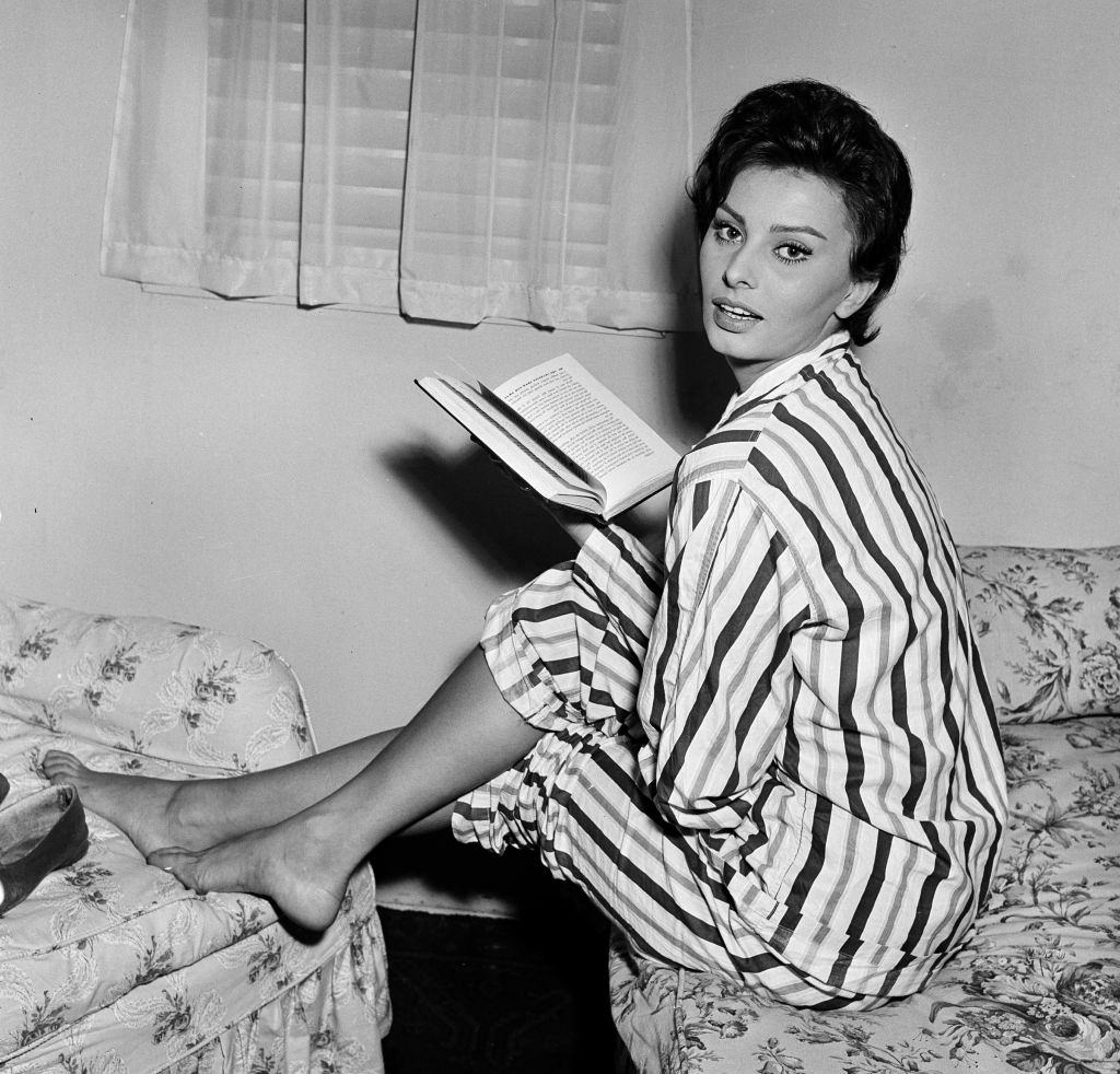 Sophia Loren reading a book while making the film "The Key" at Elstree Studio's, 1957.