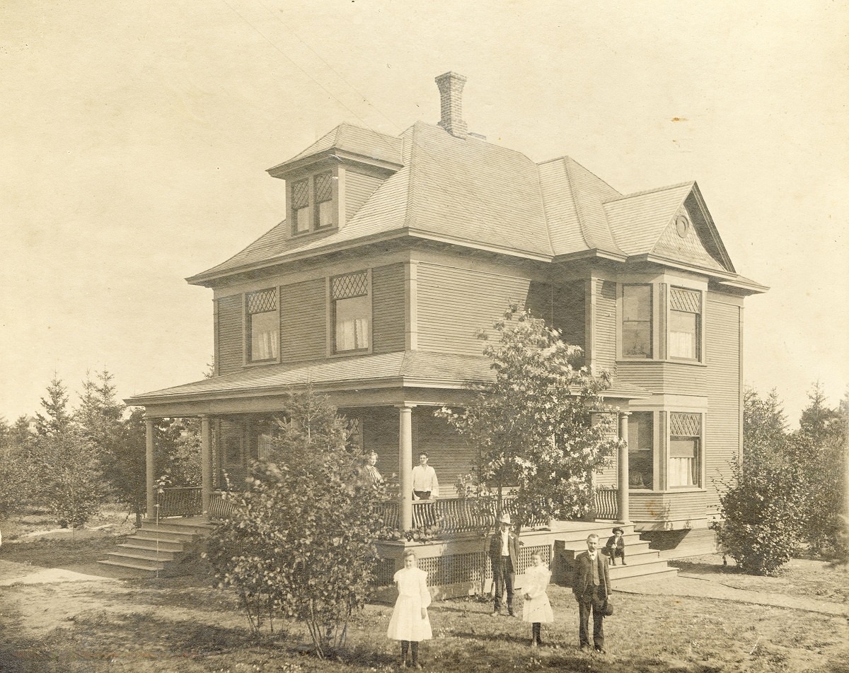 Family posing outside of a house on Alberta Street, 1904.