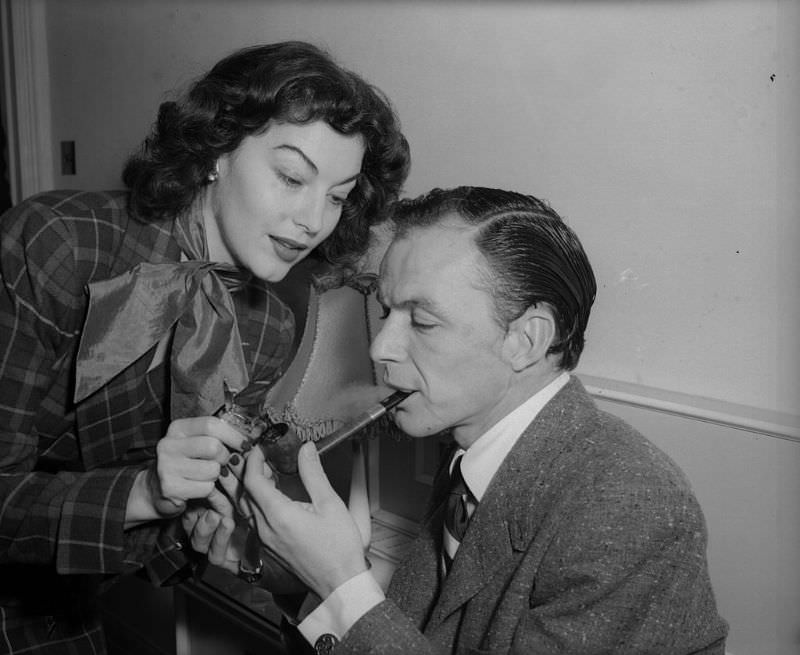 Ava Gardner lighting a pipe for Frank Sinatra, 1951.