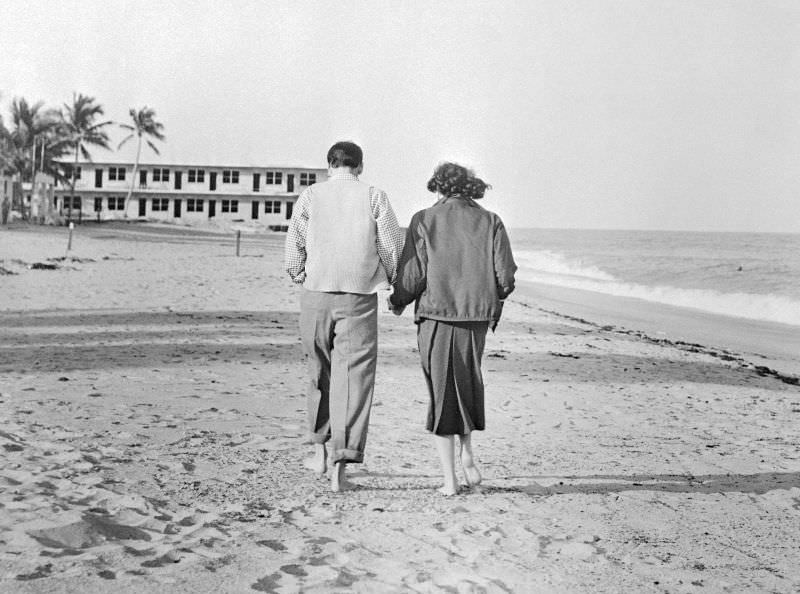 Frank Sinatra and Ava Gardner strolling along a beach in Miami, two days after tying the knot, 1951.