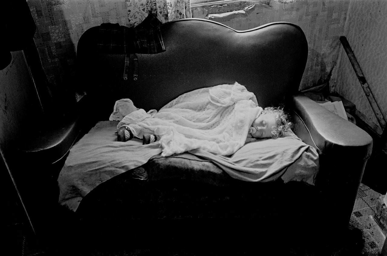 Baby asleep in slum property Balsall Heath 1970