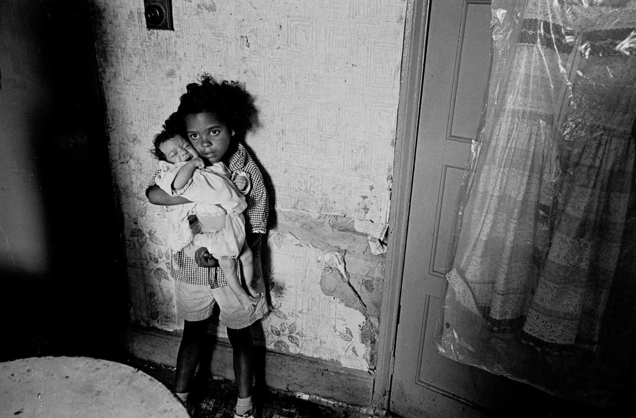 Young girl with her baby sister, slum property Balsall Heath 1970