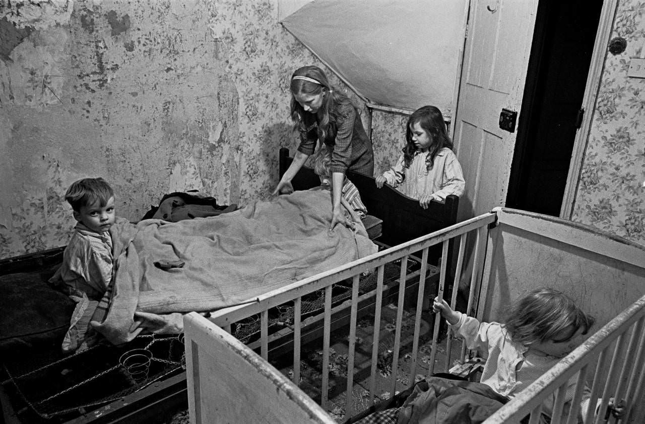 Mrs Milne puts her children to bed in the winter, Balsall Heath 1968