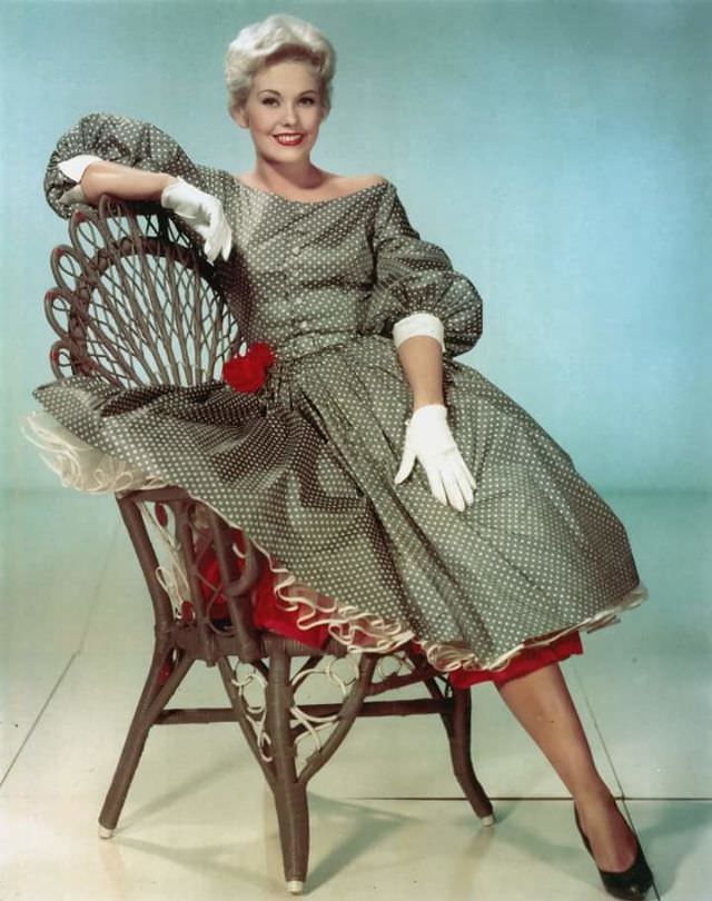Kim Novak is resplendent in a lightweight taffeta summer dress and gives all a lovely view of her petticoats