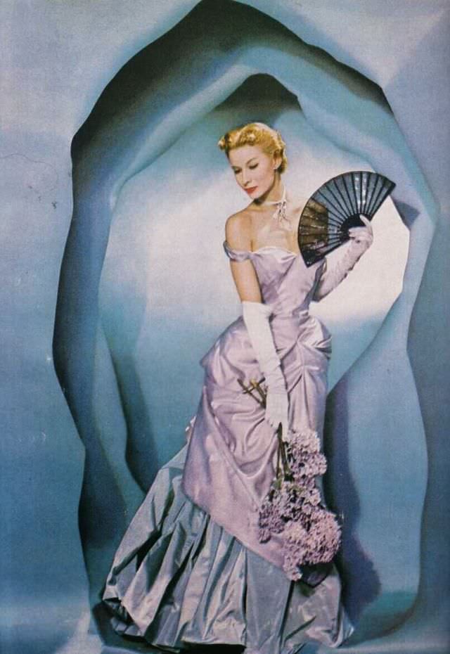 Lisa Fonssagrives poses in a luxurious two-tone taffeta gown by Charles James