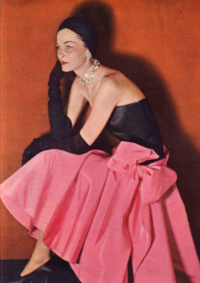 Model in strapless silk taffeta dress designed by Norman Norell