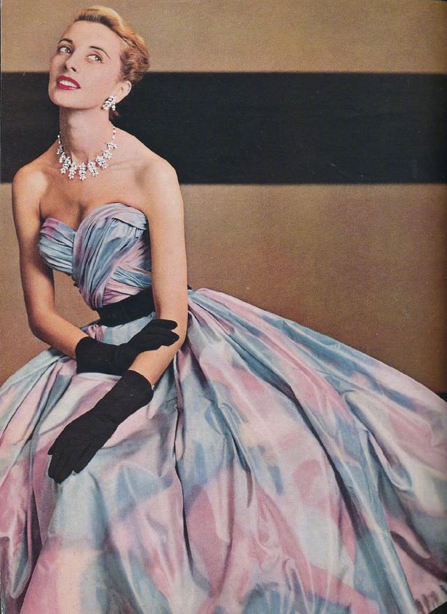 Model is wearing a beautiful taffeta strapless evening gown by Pierre Balmain