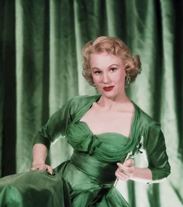 Virginia Mayo is ready for St. Patrick's day in a fabulous gown of whispering taffeta