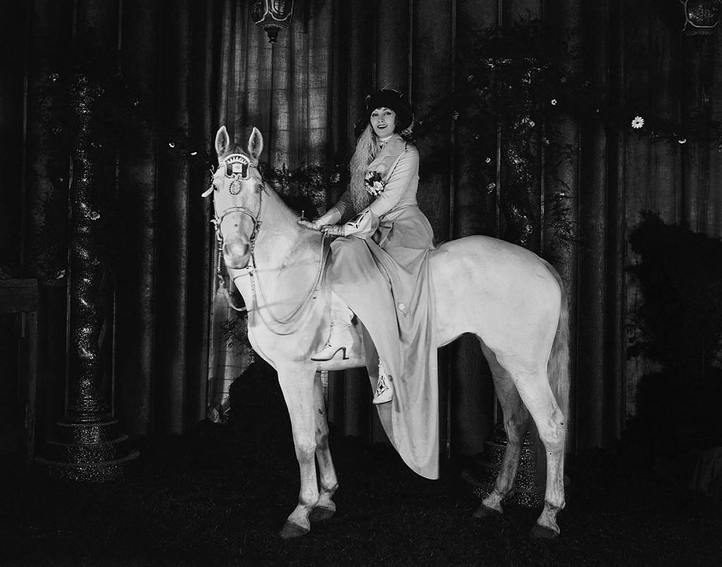 Greta Garbo sitting on a horse, 1926.