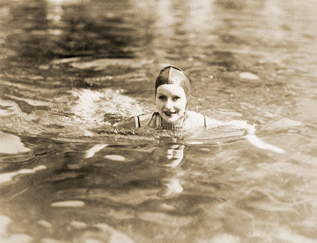 Greta Garbo swimming at a beach, 1920s.