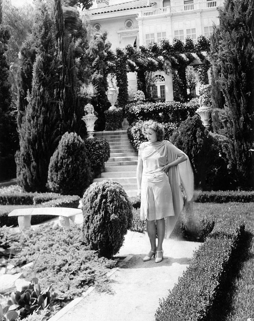 Greta Garbo standing in the garden of her Hollywood villa. Los Angeles, 1920s