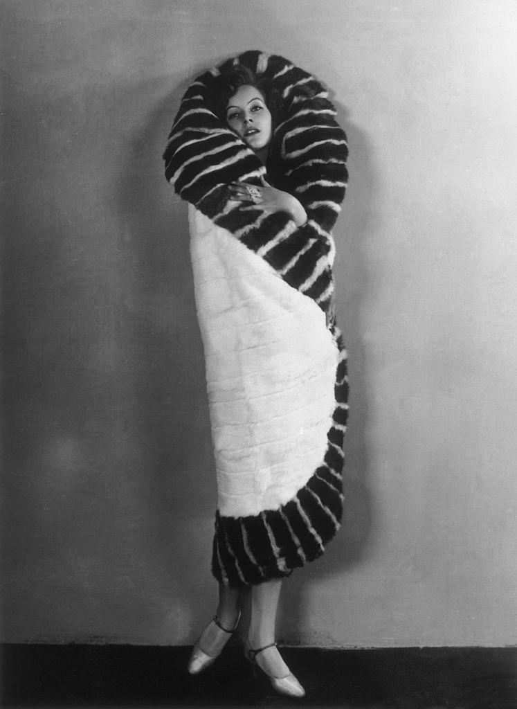 Greta Garbo wearing a white fur wrap from New York designed for an evening at the theatre, 1925.