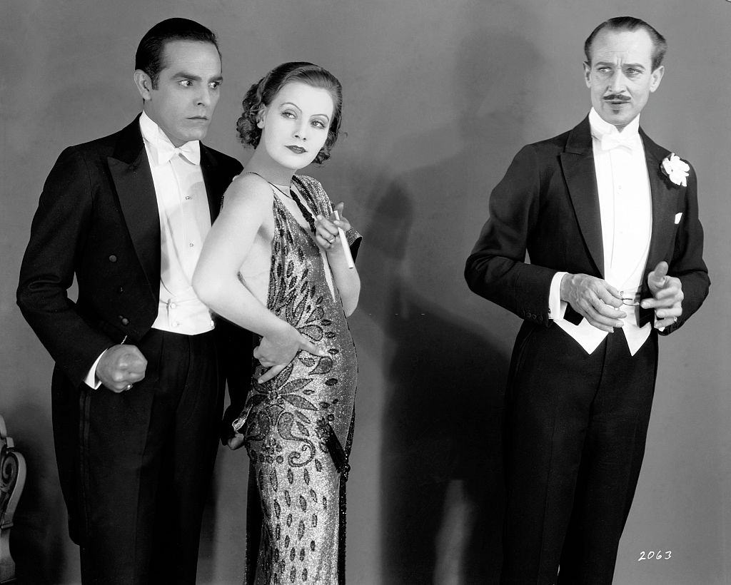 Greta Garbo with actor Antonio Moreno and HB Warner on the set of "The Temptress", 1924.