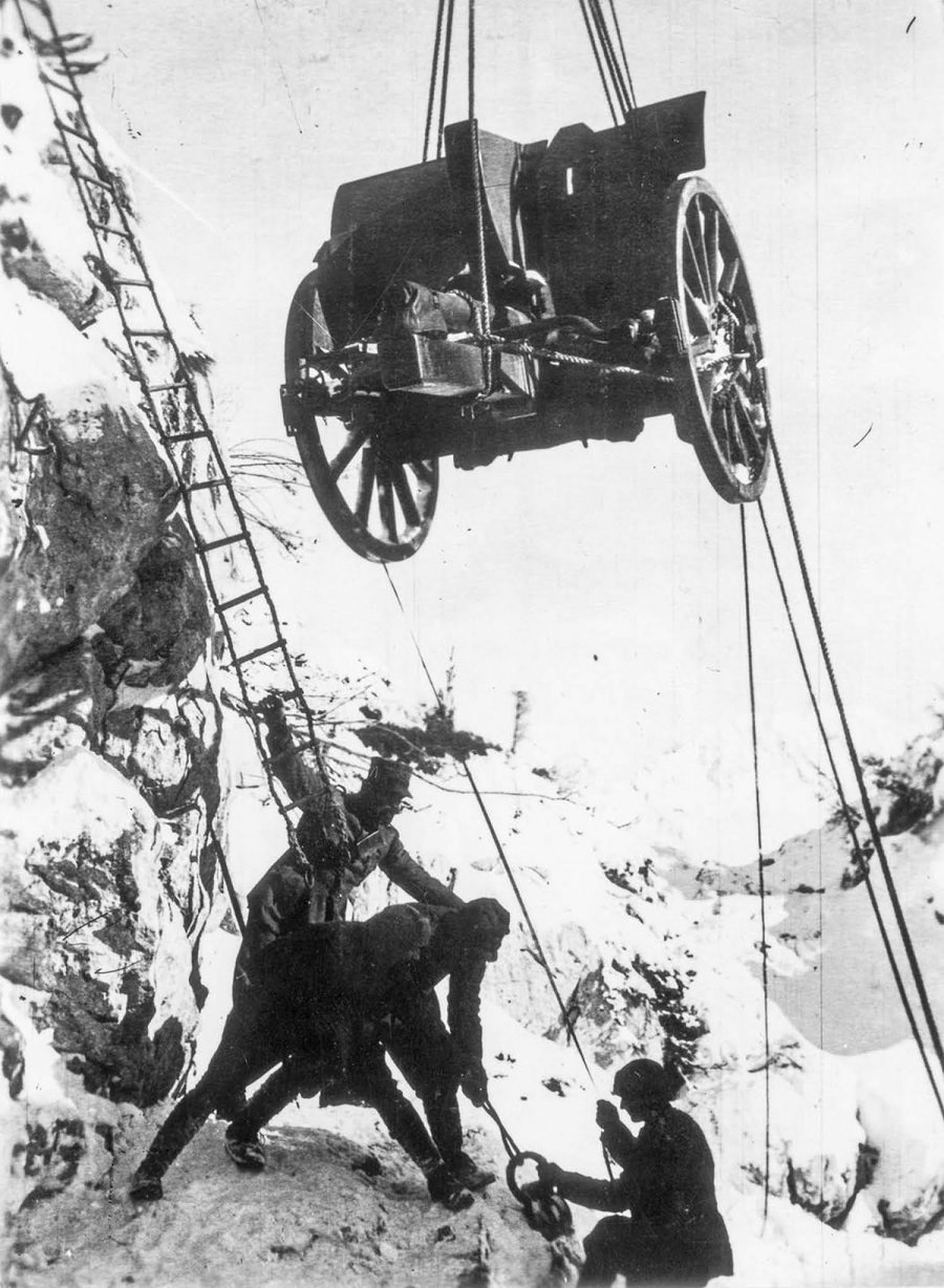 Soldiers hoist a field gun up a cliff face. 1917.