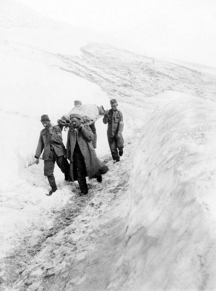 Austro-Hungarian soldiers carry a wounded comrade to a field hospital on Monte Nero. 1916.