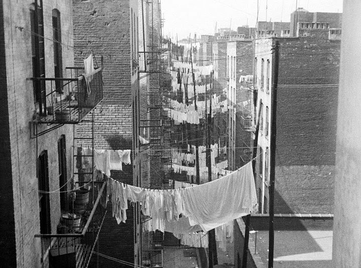 A view down an alley, as rows and rows of laundry hang from tenements, New York City, ca. 1930s. Seen looking west from 70 Columbus Avenue or Amsterdam Avenue at 63nd Street. (NYC Municipal Archives)