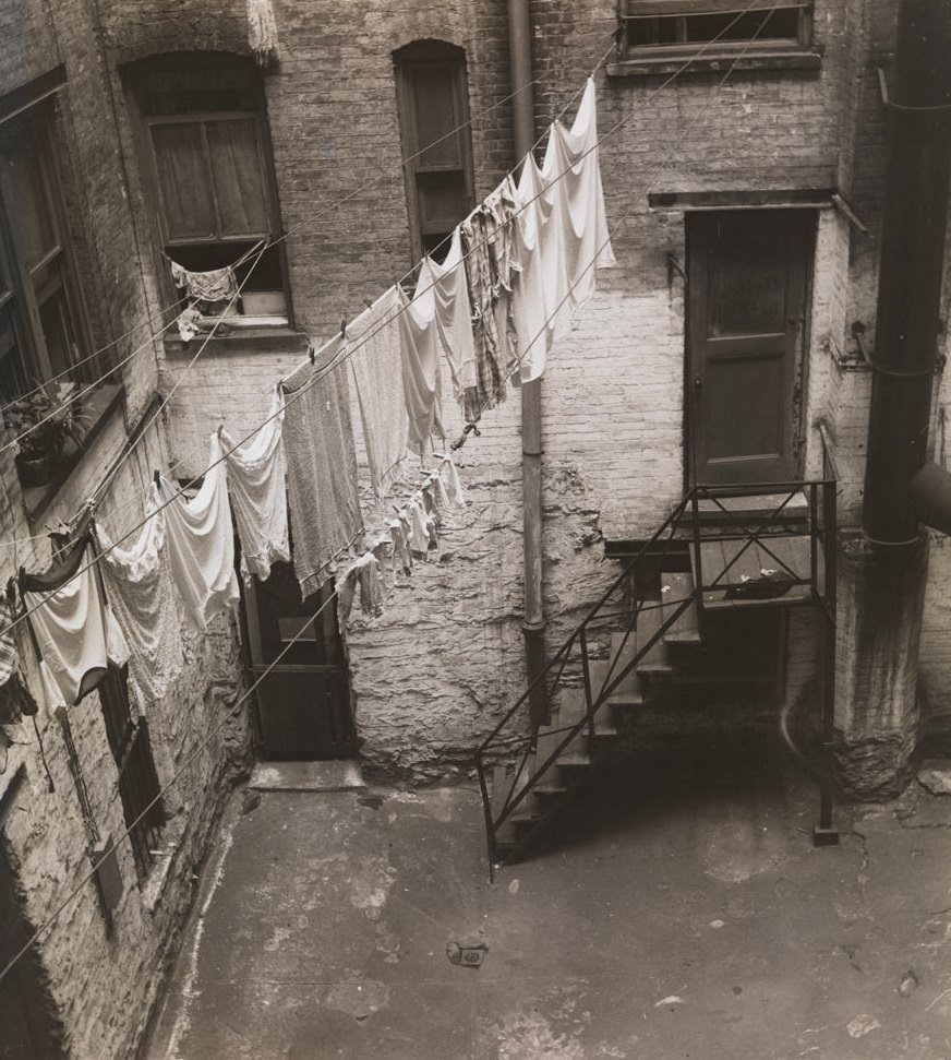 View of clothesline strung between windows in brick courtyard, 1392 Madison Ave. ca. 1933. (Museum of the City of New York)