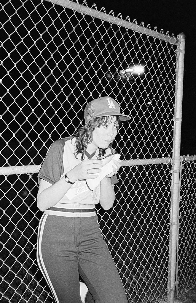 Mackenzie Phillips enjoying a hot dog during a game, 1980.