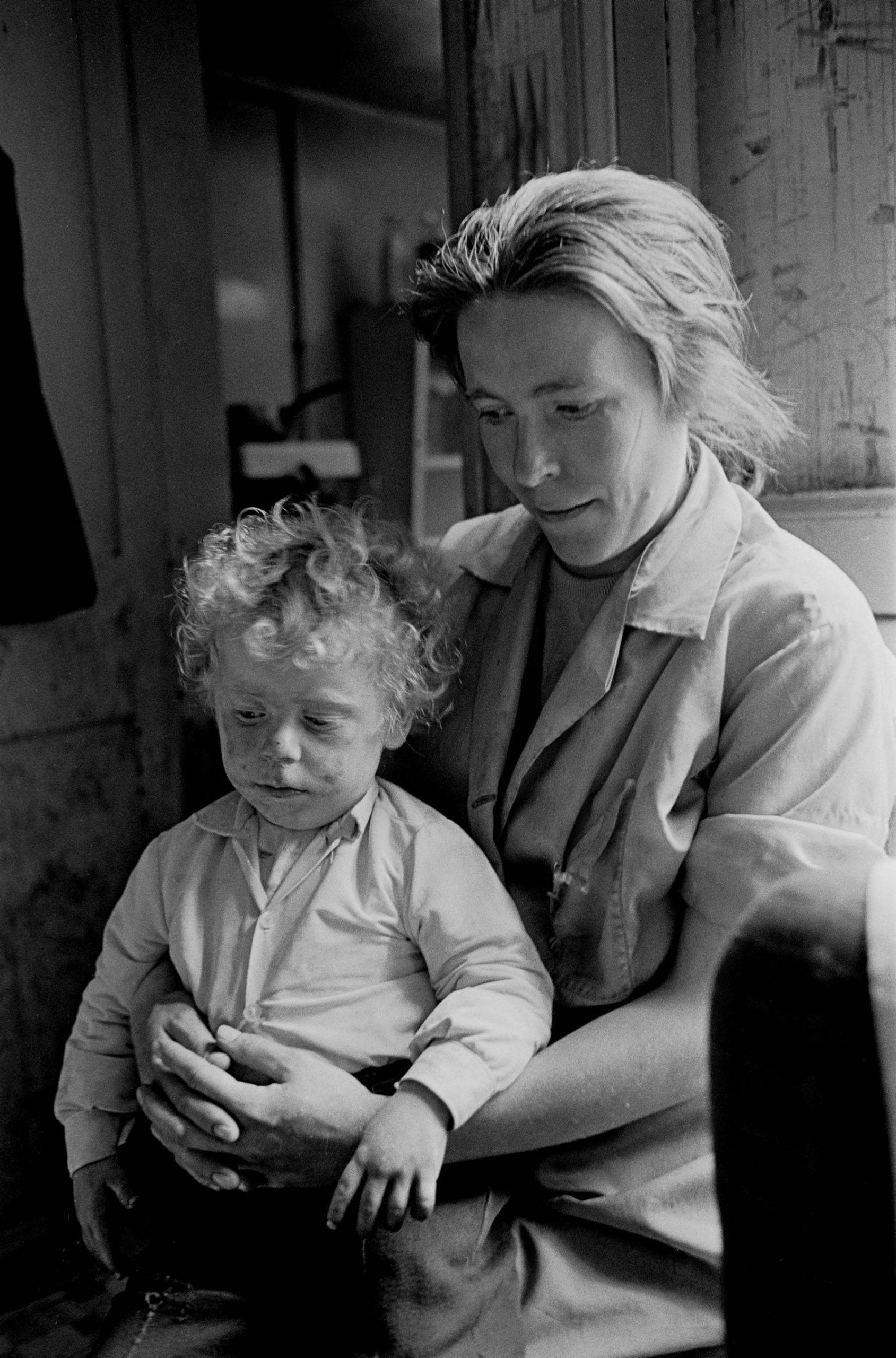 Mother and toddler in Manchester slum housing 1971