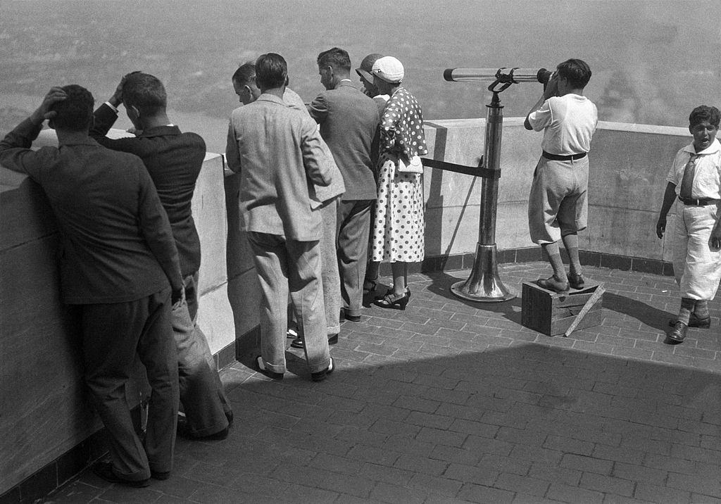 Tourists looking at the view from the Empire State Building, New York City, New York, circa 1930.
