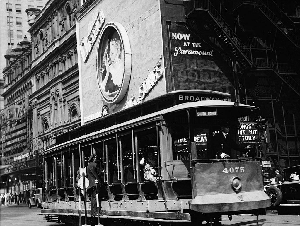 An open trolley and Paramount Theater 43rd Street, New York City, 1930.