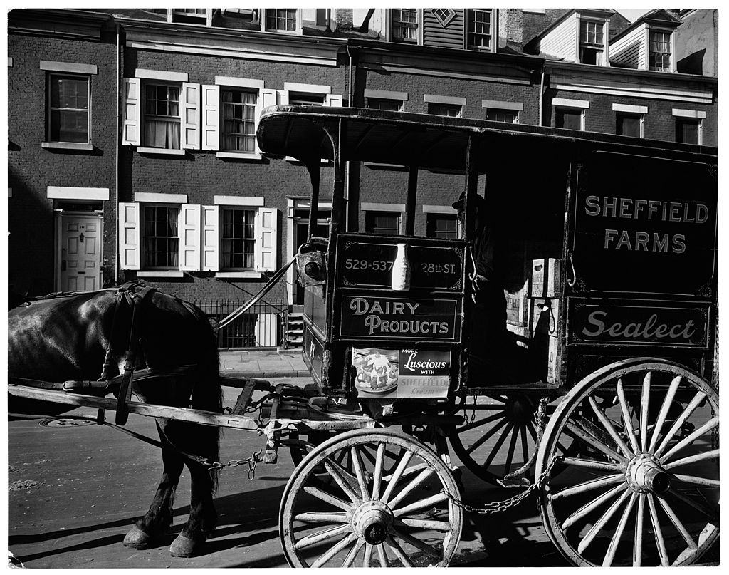 A milkwagon and old houses, New York City, 1936.