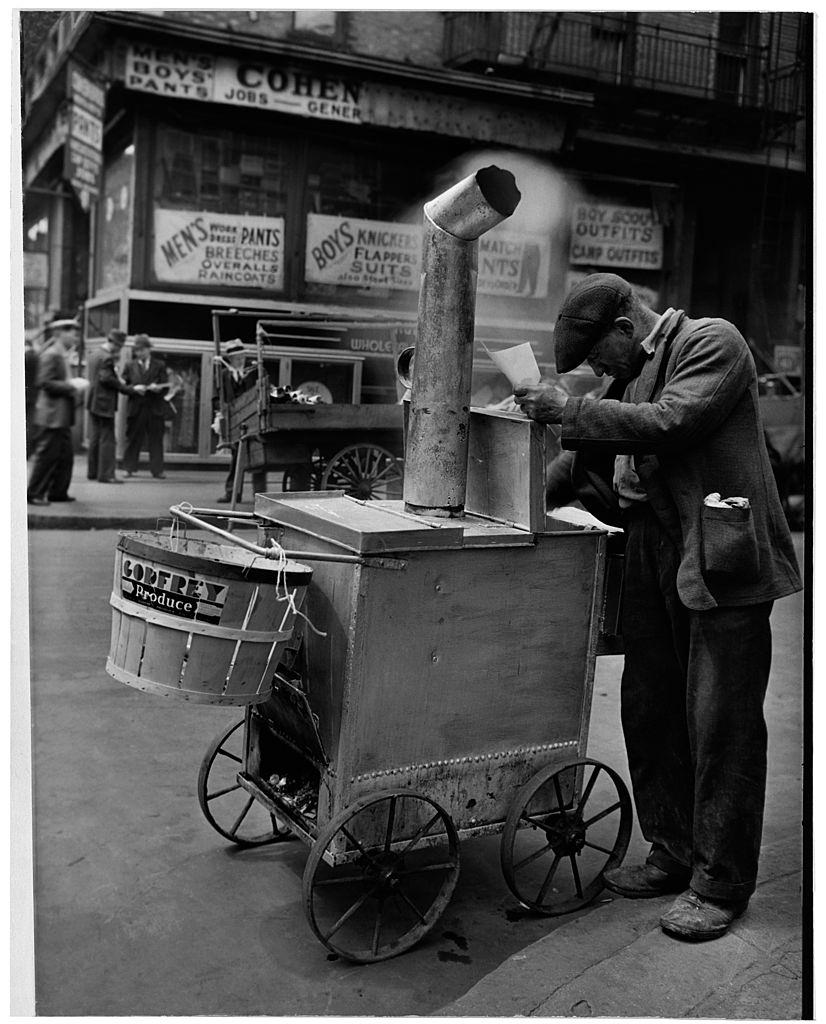 A man selling roast corn, New York City, 1938.