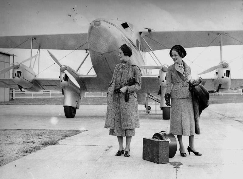 Models posing for a fashion shoot in front of a Qantas biplane, Queensland