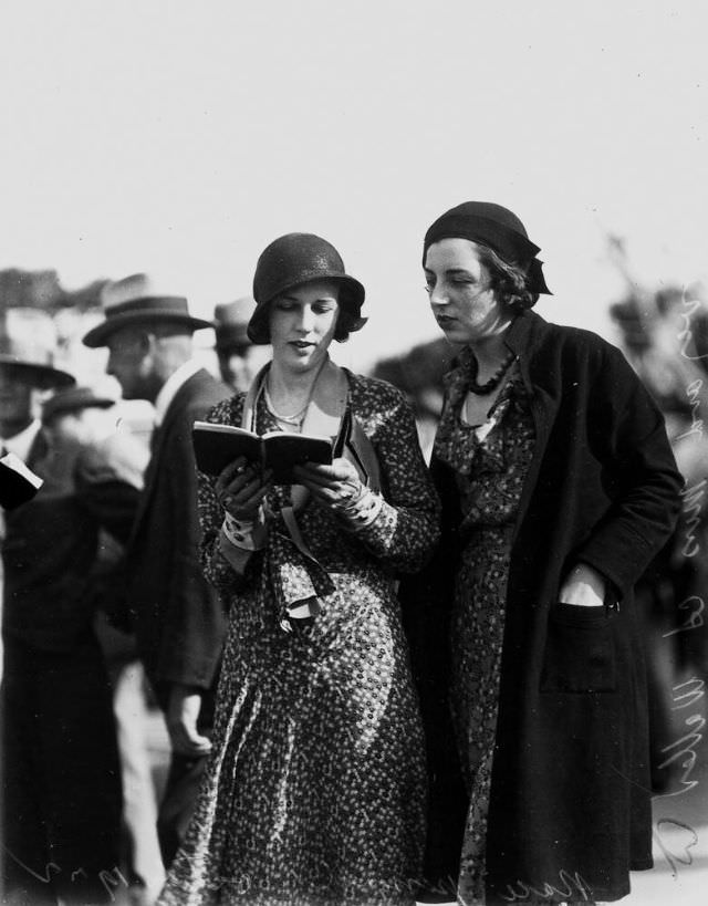 Two young ladies picking a winner at Albion Park racecourse, Brisbane, Queensland