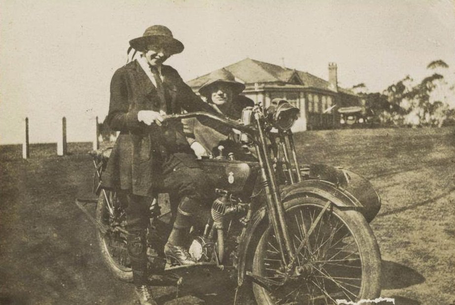 Two women posing with a motorbike and sidecar, 1922.