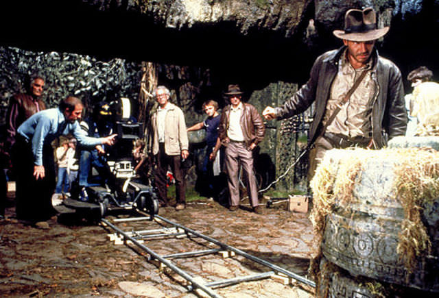 That's noted Indiana Jones stunt double Vic Armstrong standing to the left of Harrison Ford