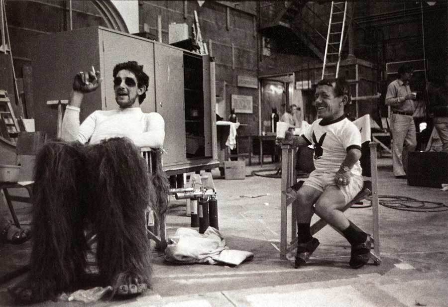 The actors behind Chewbacca and R2D2 take a break onset.