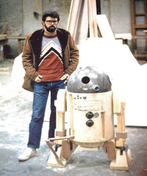George Lucas poses for a picture with R2D2 during filming of A New Hope.