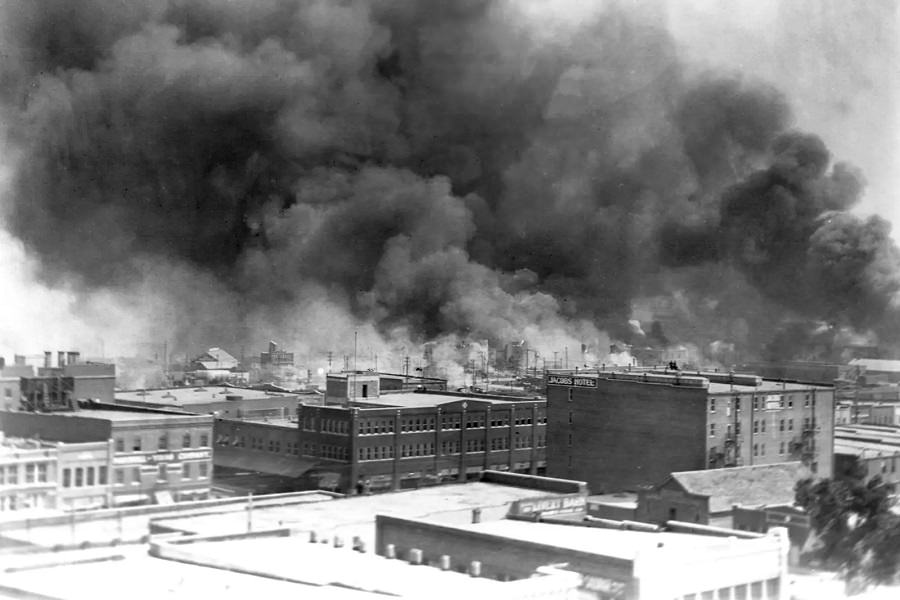 Black smoke billows from fires during the Tulsa massacre in the Greenwood District, June 1921.