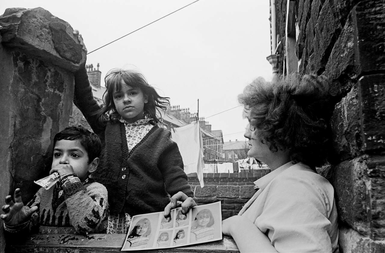 Mother and children with school photos, Bradford 1969