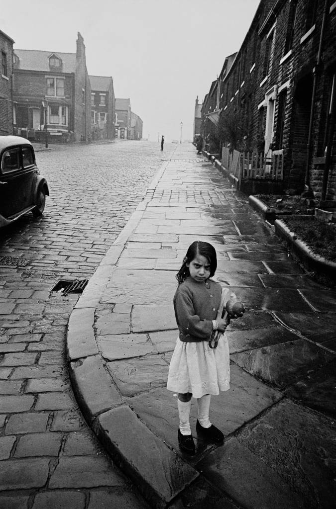 Girl playing on a Bradford street corner, 1969