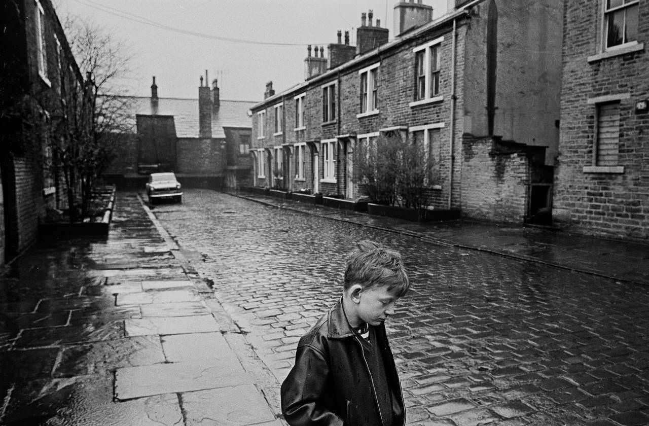 Boy standing in the rain, Forster St Bradford, 1969
