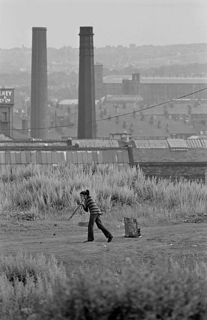 A young boy playing cricket, 1969